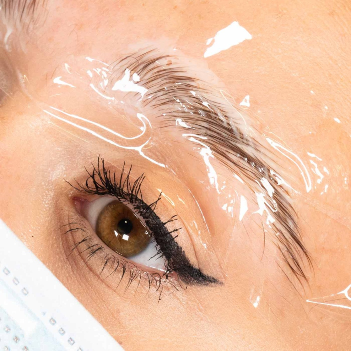 Eyebrow lamination treatment with cling film over brow